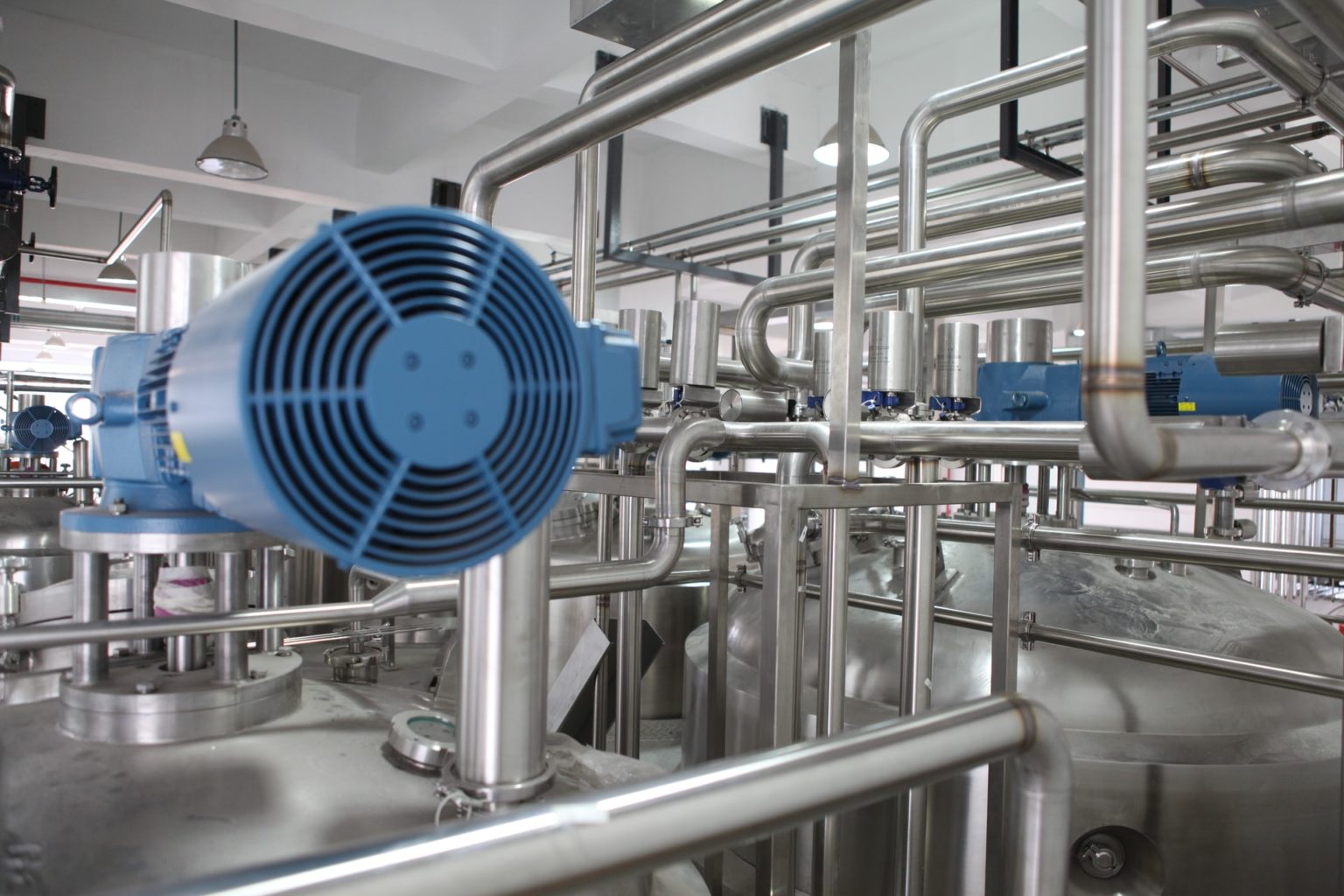 a large factory with blue pipes