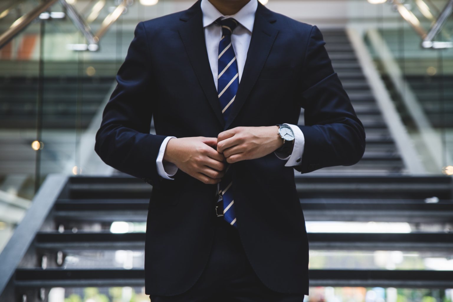 a person in a suit shaking hands