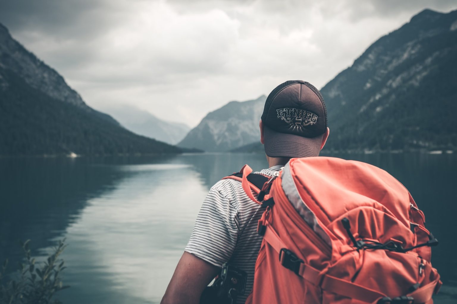 a man wearing a mask and standing near a body of water