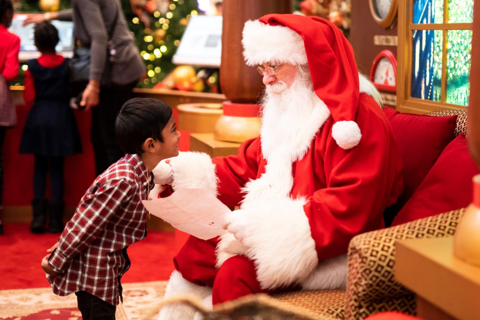 a person in a santa costume holding a baby