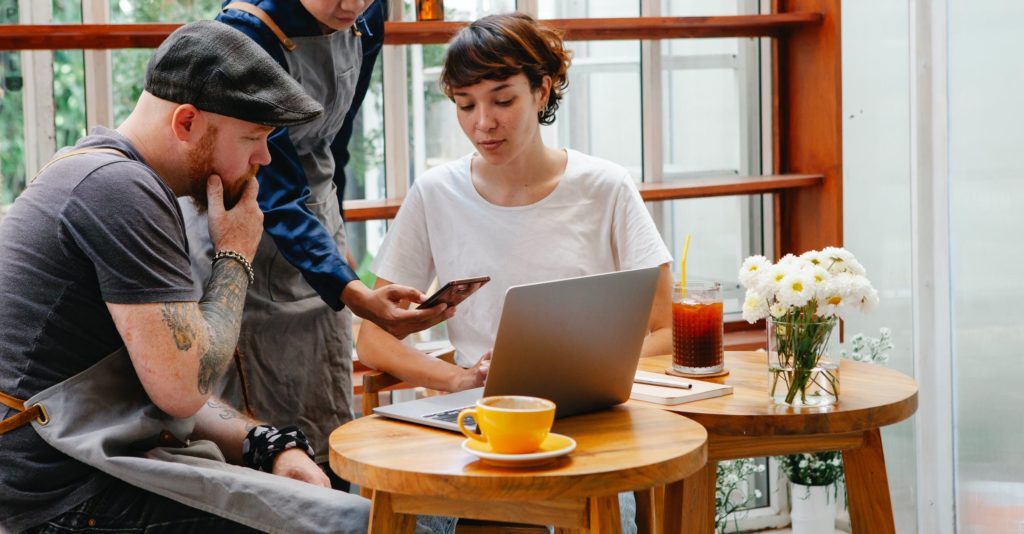 a man looking at a woman on a cell phone