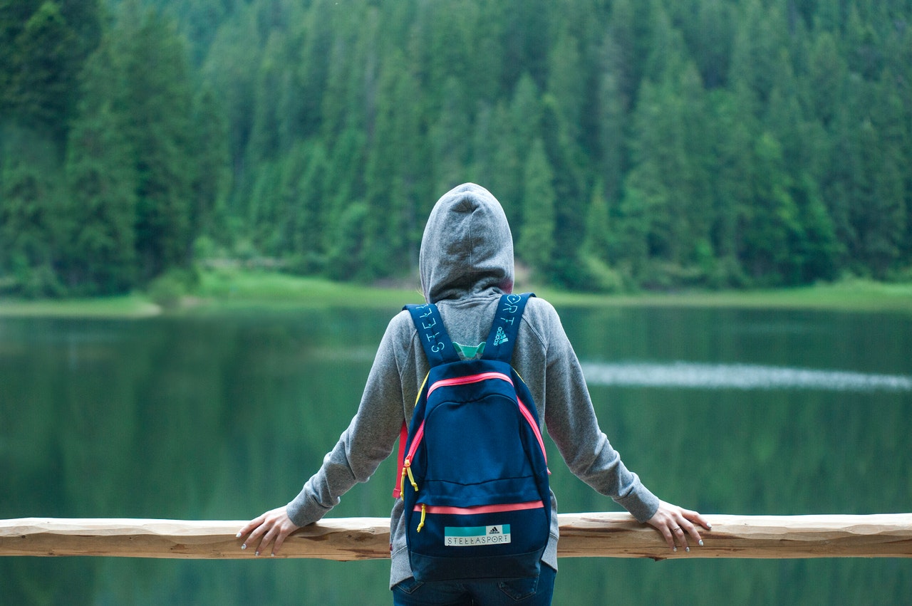 a person in a costume looking at a body of water