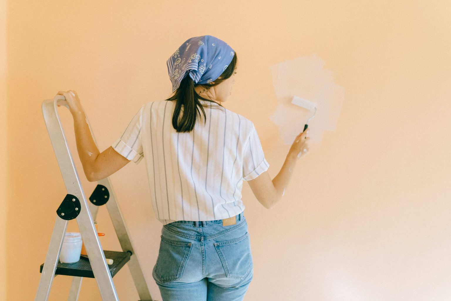 a person painting a wall