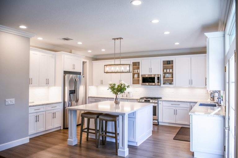 a kitchen with white cabinets